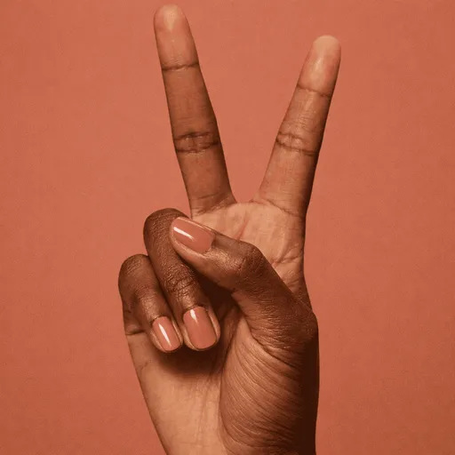 Reddish-brown nails forming peace sign