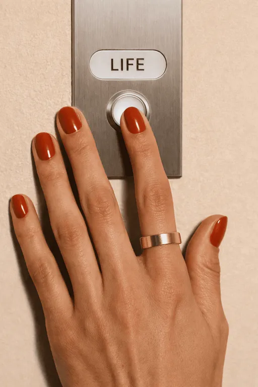 Red-orange nails pressing elevator button